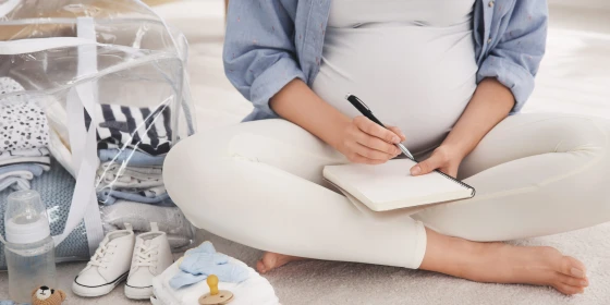 Pregnant,Woman,Packing,Bag,For,Maternity,Hospital,At,Home,,Closeup