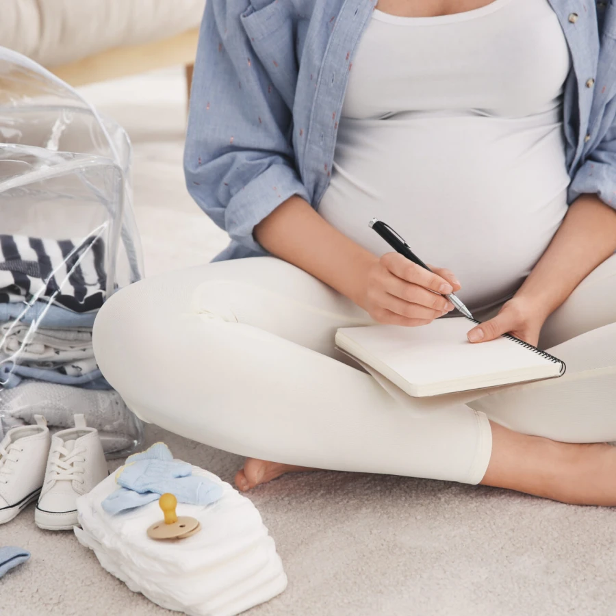 Pregnant,Woman,Packing,Bag,For,Maternity,Hospital,At,Home,,Closeup