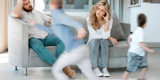 Headache,,Parents,And,Children,By,Sofa,With,Adhd,,Running,And